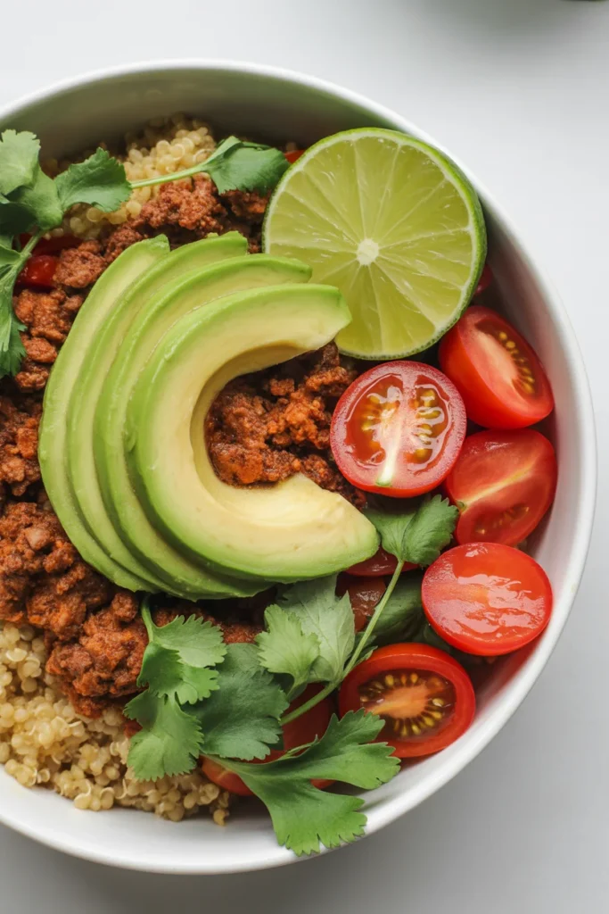 High-protein ground beef and quinoa power bowl with avocado and fresh toppings — healthy 30-minute meal prep recipe